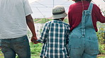 Family, back and walking with holding hands on farm for agriculture or natural sustainability in greenhouse. Dad, mom and child with farmland for agro business, conservation or growth in nature