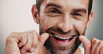 Dental health, face and man with floss in studio for cleaning, hygiene or morning mouth routine. Oral care, grooming and portrait of person with teeth string to prevent gum disease by gray background