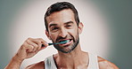 Dental health, face and man brushing teeth in studio for cleaning, hygiene or morning mouth routine. Oral care, plaque and portrait of person with toothbrush to prevent gum disease by gray background
