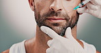 Hands, cosmetologist and man with face injection in studio for skincare, antiaging and collagen. Cosmetic, needle and beautician with person for facial transformation with filler by gray background