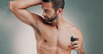 Deodorant, hygiene or man with perfume spray for odor control, fresh armpit smell or morning routine. Antiperspirant, portrait or happy person with grooming product for self care on studio background