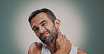 Man, face and massage neck in studio, joint tension and stress with medical risk on gray background. Portrait, frustrated and mature person with mental health, muscle and pressure for pain relief
