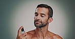 Man, perfume and spray for hygiene, wellness or luxury fragrance for face cosmetics. Beauty, grooming and fresh cologne bottle for aesthetic, aroma and odor prevention product on studio background