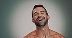 Face, smile and man laugh for skincare with facial glow, natural cosmetics and dermatology results. Portrait, person and funny joke with grooming routine, self care and treatment on studio background