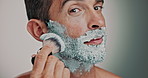 Face, man and brush to shave for skincare foam, hair removal and facial hygiene for self care. Portrait, person and tools with grooming routine, dermatology cream and maintenance in studio background