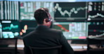 Man, back and screen with headphones for stock market investment, finance or monitoring graphs. Male person, broker or financial advisor with blur for trading advice or cryptocurrency at call center