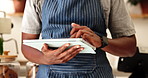 Hands, man and waiter on tablet at cafe for research, online order and booking for menu update. Male person, typing and digital for inventory management, review customer service and sales performance