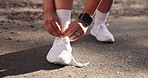 Man, hands and tie laces for workout preparation, outdoor and active shoes for running. Fingers, road and person with legs for exercise in countryside, sneakers and getting ready for training start