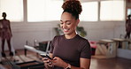 Phone, fitness and woman at pilates class typing for communication online with mobile app. Health, studio and female person with cellphone for social networking or contact on media with exercise.