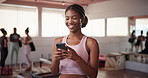 Cellphone, happy and woman at pilates class typing for communication online with mobile app. Health, studio and female person with phone for social networking or contact on media with exercise.