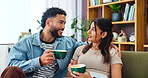 Couple, living room and coffee break for gossip, conversation or funny story on sofa at home. Man, woman and morning support with discussion, communication and listen with beverage or drink at house