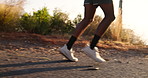 Man, cardio and legs in nature for fitness, outdoor and running shoes for wellness goals. Mountain, road and active sneakers for exercise in countryside, marathon training and street for sports