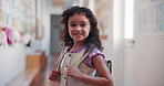 Education, smile and face of girl at school for learning, knowledge and future. Child development program, studying and growth with kid in hallway of Stem academy for students, classroom and youth