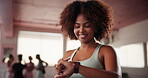 Woman, gym and check goals on smart watch, cardio statistics and results of workout on app. Exercise, person and monitor health information at wellness club, progress update and tracking target time