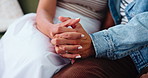 Holding hands, love and couple in home with marriage, care and support in relationship. Romance, trust and man with woman for connection, bonding and commitment together on sofa in apartment.