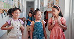 Education, youth and walking with friends at school for recess, growth and learning. Students, knowledge and child development with group of kids in hallway of academy for scholarship and support 