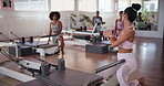Fitness, personal trainer and start with group in class for instruction, exercise or performance. Challenge, getting ready and reformer machine with woman coaching people in gym for development