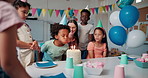 Children, celebration and blow candles for birthday party with teacher, friends and students at school. Kids, cake and happy people at social gathering, congratulations and special event in classroom