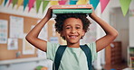 Balance, books and face of boy student in school classroom for development, growth or learning. Future, knowledge and smile with happy child in academy for elementary study or youth scholarship
