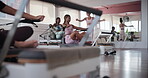 Fitness, personal trainer and workout group in class for instruction, exercise or performance. Challenge, reformer machine and woman coaching students in gym for development or strength improvement