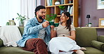 Couple, living room and cheers with coffee for chat, conversation or gossip on sofa at home. Man, woman and morning toast with discussion, communication and listen with beverage or drink at house