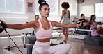 Breathing, fitness and personal trainer with workout group in class for instruction, exercise or performance. Challenge, pilates and reformer machine with woman coaching students in gym for strength
