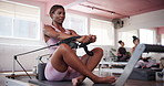 Pilates, reformer machine and woman in gym for workout, body balance and health in class. People, fitness training or core strength exercise in yoga studio for resistance, wellness and flexibility