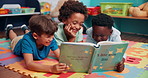 Reading, group and children with book in classroom for learning, development or growth. Kids, relax and boy students with storytelling on floor mat for literacy knowledge at elementary school.