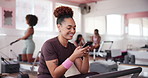 Happy woman, gym and browsing with phone for fitness, sports app or news at health club. Active, female person or athlete with smile on mobile smartphone for workout break, exercise or training tips