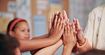 Teacher, students and high five in classroom, hands and support with mind development at academy. Education, motivation huddle and gesture for learning success, school celebration and woman with kids