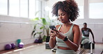 Gym, woman and chat with smartphone for fitness, virtual tutorial and communication on social media. Health club, female person and smile with mobile for application, exercise video and workout break