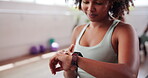 Woman, gym and check statistics on smart watch, cardio goals and results of workout on app. Exercise, wrist and monitor health information at wellness club, progress update and tracking target time