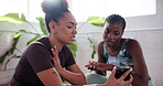 Women, friends and talk with phone in yoga class of streaming video, research and fitness guide. People, discussion and explaining with mobile for social media, pilates website and online instruction