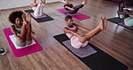 Fitness, stretching and group of women, gym or exercise for wellness in class, balance or pilates. Performance, active and people with routine for legs, health club and warm up for workout in morning