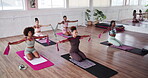 Exercise class, pilates and resistance band with people in studio for fitness or training together. Challenge, equipment and tension with personal trainer in group session at gym for strength workout