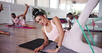 Breathing. exercise class and resistance band with people in studio for fitness or training together. Legs, pilates and tension with personal trainer in group session at gym for strength workout