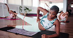 Legs, fitness or woman with resistance band in pilates class for body health, strength exercise or wellness. Floor, training or group workout, stretching muscle or energy with side lying raise in gym
