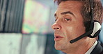 Airport, headset and surveillance with man in control room to monitor climate or weather. Communication, feedback and satellite update with operator in air traffic office for geology or meteorology