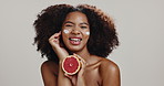 Skincare, grapefruit and black woman with cream in studio for organic cosmetics, beauty and wellness. Dermatology, white background and portrait of person with fruit for health, benefits or vitamin C