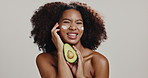 Skincare, face cream and black woman with avocado in studio for organic cosmetics, facial and beauty. Dermatology, white background and portrait of person with fruit for health, benefits or vitamins