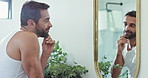 Man, confidence and mirror for skincare in bathroom of facial results, beauty and wellness benefits. Male person, reflection and touch with dermatology check, natural cosmetics and self care at house