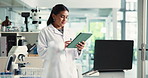 Woman, scientist and scroll on tablet in lab for research, medical report and record investigation. Person, digital and feedback for experiment, review checklist and healthcare information on vaccine