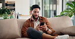 Smile, man and relax with phone at house for browsing social media, communication and reading blog. Happy, male person and mobile with chatting, message to contact and typing feedback of notification