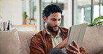 Typing, chat and tablet with man on sofa for social media post, reading and online update. Networking, newsletter subscription and connection with person in living room at home for relax and scroll