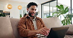Laptop, remote work and smile with man on sofa in living room of home for planning or proposal. Computer, problem solving and solution with happy freelance employee in apartment for development
