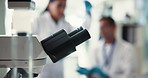 Microscope, closeup and medical research in lab for chemical testing, science experiment and study. Scientist, biotechnology and liquid with healthcare safety, particles evolution and vaccine results