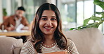 Woman, face and relax on sofa, happy and confidence with break in living room at apartment. Girl, smile and portrait on couch in morning, lounge and chill for comfort with rest at house in India