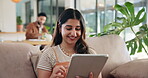 Typing, smile and tablet with woman on sofa for social media post, reading and online update. Networking, newsletter subscription and connection with person in living room at home for chat and scroll