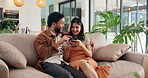 Phone, pointing and smile with couple on sofa in living room of home for communication or social media. App, love or mobile search with man and woman in apartment together for bonding or browsing