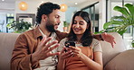 Phone, pointing and social media with couple on sofa in living room of home for communication or browsing. App, conversation or mobile search with man and woman in apartment together for bonding